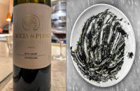 Wine and Risotto Nero, cuttlefish in ink and gremolata, Bocca Di Lupo, London © 2023 Keith Trumbo